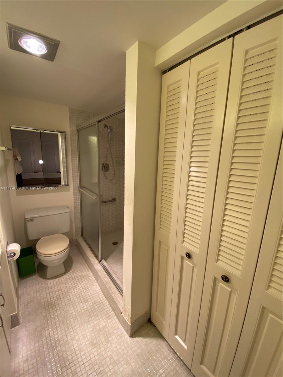 4034 Rexford B, Unit 4034 Boca Raton, FL 33434 - Photo 7 of 15 a bathroom with a toilet and a shower