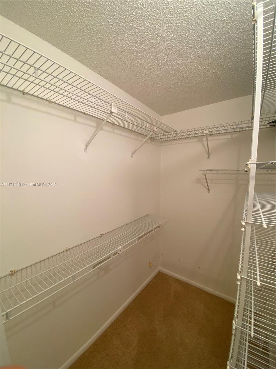 4034 Rexford B, Unit 4034 Boca Raton, FL 33434 - Photo 8 of 15 a view of a room with racks on the wall
