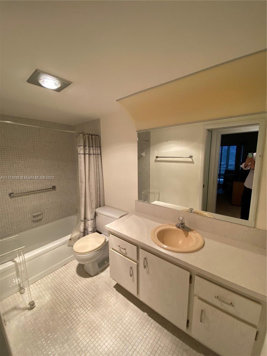 4034 Rexford B, Unit 4034 Boca Raton, FL 33434 - Photo 9 of 15 a bathroom with a granite countertop sink and a mirror