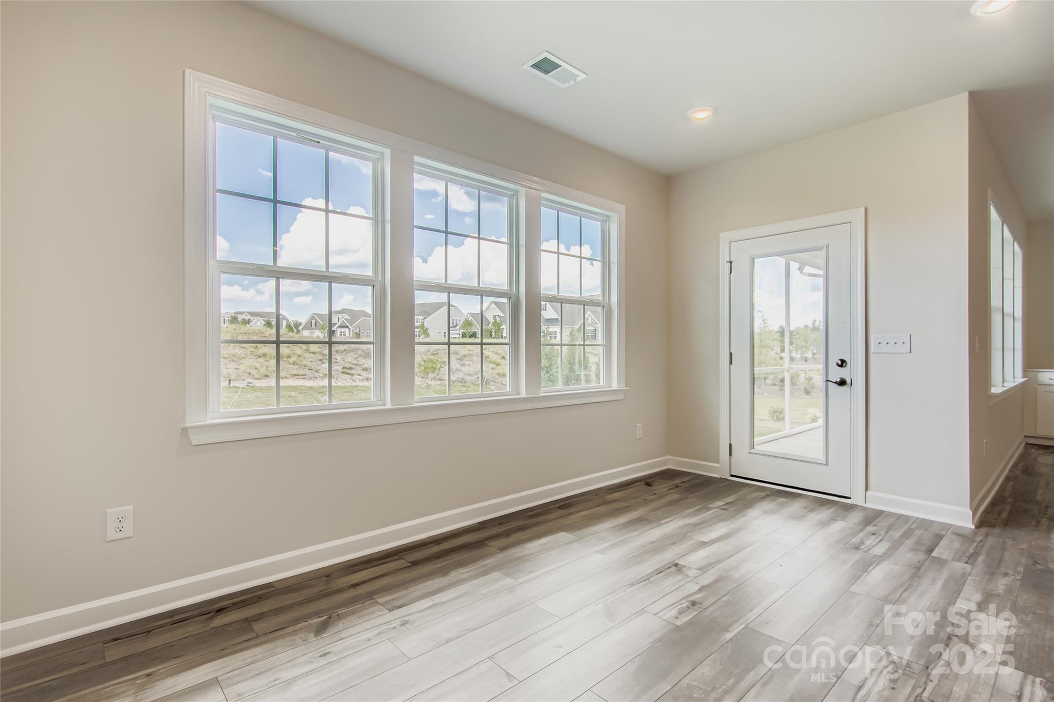 2238 Moon Crst Road Lancaster, SC 29720 - Photo 7 of 16 an empty room with wooden floor and windows