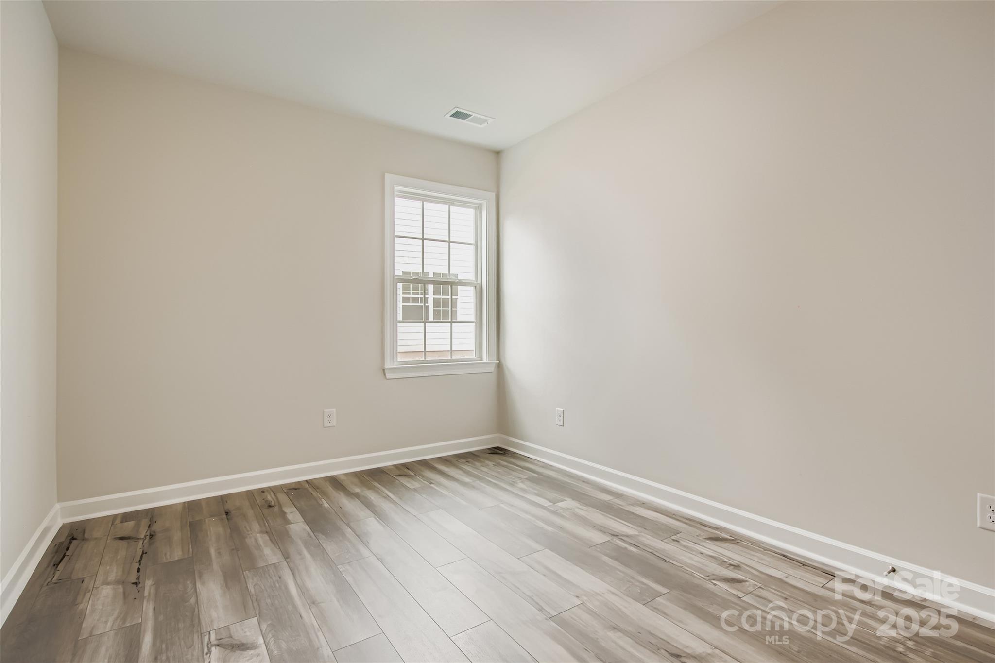 2238 Moon Crst Road Lancaster, SC 29720 - Photo 9 of 16 an empty room with wooden floor and windows