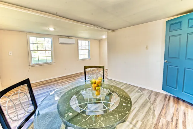 a view of a livingroom with furniture window and wooden floor