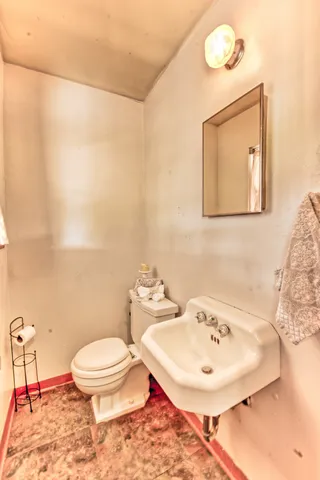 a bathroom with a sink a toilet and mirror