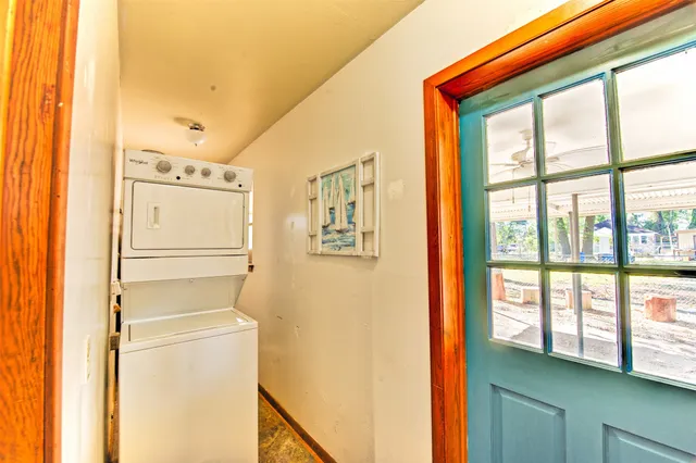 a large kitchen with kitchen island granite countertop a sink and white cabinets