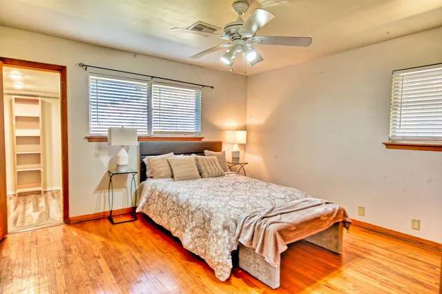 a bedroom with a large bed and a chandelier