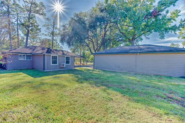 a view of an empty room with a windows and a fireplace