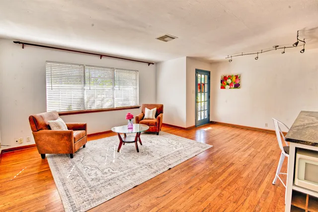 a living room with furniture a rug and a large window