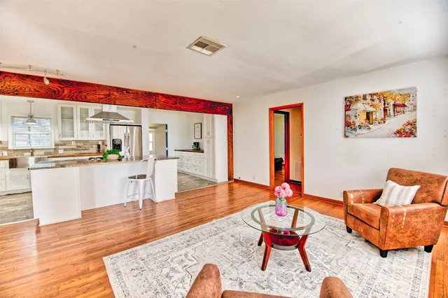 a living room with furniture and wooden floor
