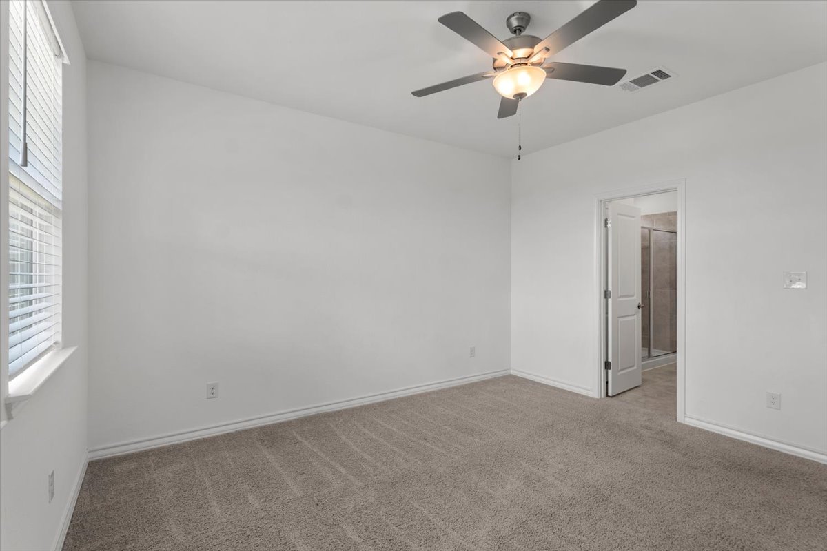 500 Stinchcomb Road Hutto, TX 78634 - Photo 32 of 37 A quiet bedroom retreat offering soft carpeting and direct bath access.