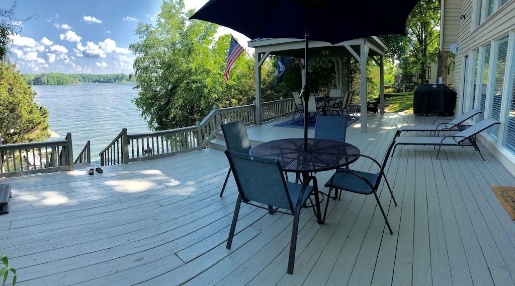 175 Holly Tree Drive Estill Springs, TN 37330 - Photo 2 of 38 a view of a roof deck with table and chairs a barbeque with wooden floor and fence