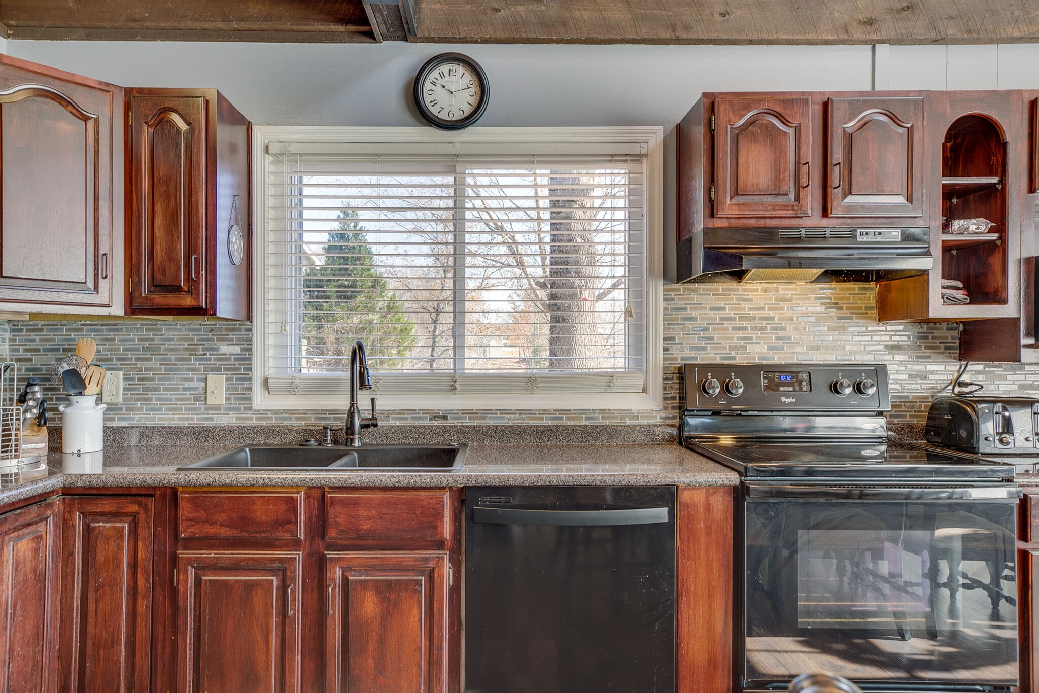 175 Holly Tree Drive Estill Springs, TN 37330 - Photo 17 of 38 a kitchen with stainless steel appliances granite countertop a sink and a window