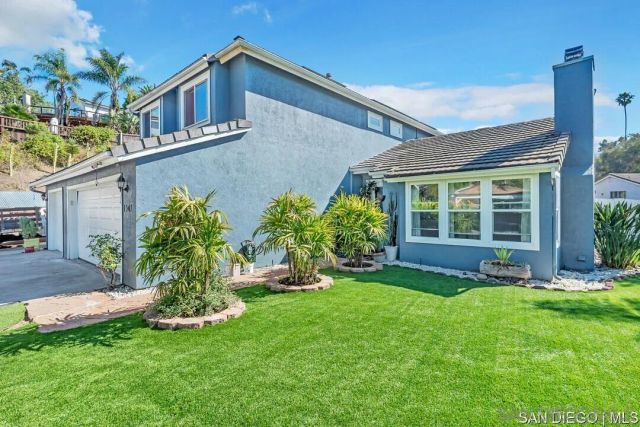 a front view of a house with a yard and porch
