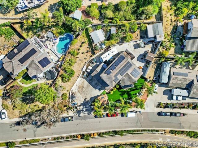 an aerial view of a house with a garden and statue