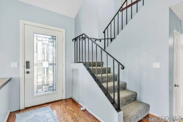 a view of an entryway with wooden floor