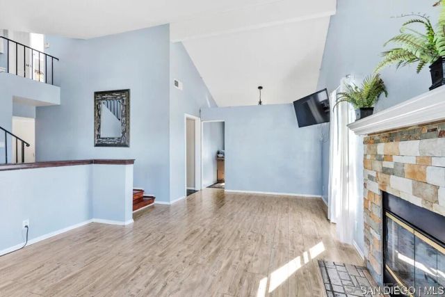 a view of a livingroom with wooden floor and a potted plant