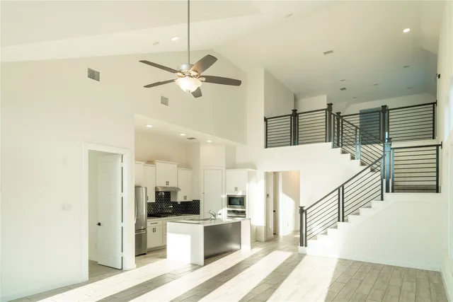 a view of a kitchen with furniture and a ceiling fan