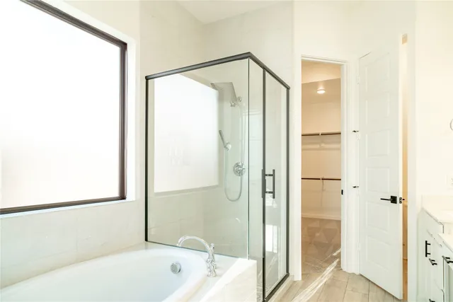 a bathroom with a bathtub and a shower