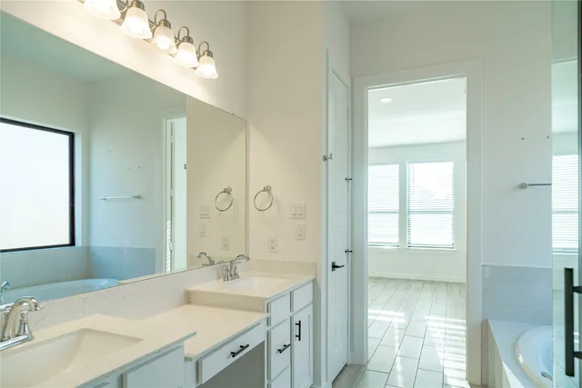 a bathroom with a sink double vanity and a mirror