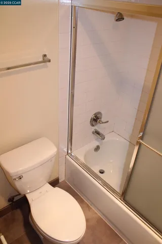 a bathroom with a toilet and a bathtub