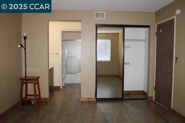 a view of a room with wooden floor