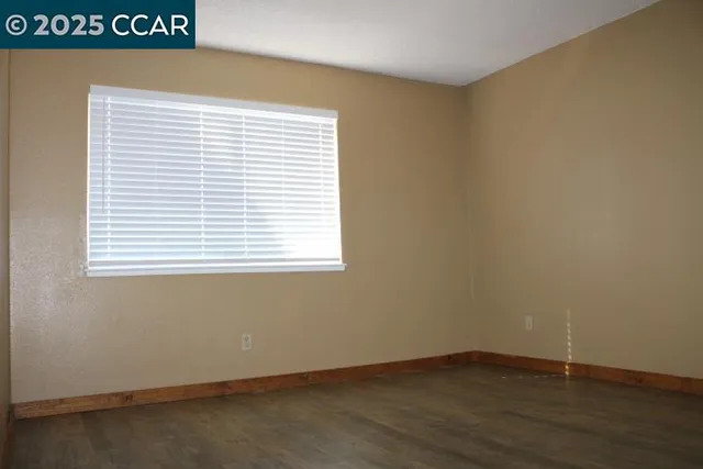 an empty room with wooden floor