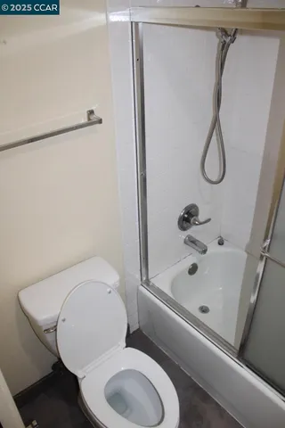 a bathroom with a toilet and a shower