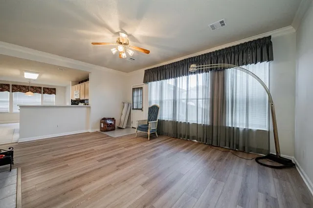 a view of a livingroom with furniture and hardwood floor