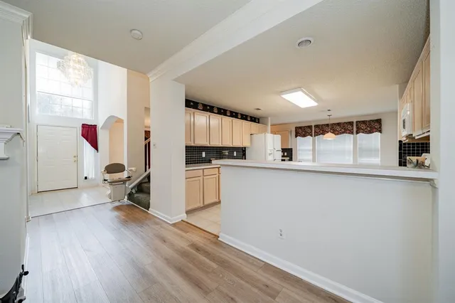a kitchen with kitchen island white cabinets and white appliances