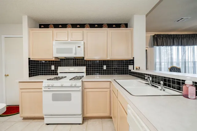 a view of a kitchen with electric appliances