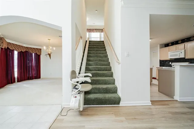 a view of entryway and hall with wooden floor