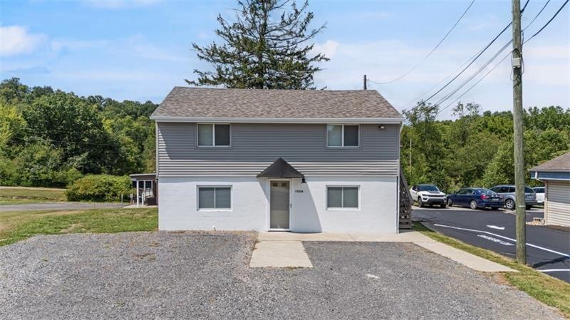 1122 Pittsburgh Road Valencia, PA 16059 - Photo 1 of 25 a front view of a house with a yard and garage