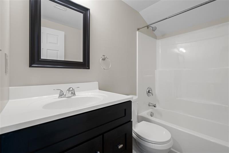 1122 Pittsburgh Road Valencia, PA 16059 - Photo 12 of 25 a bathroom with a toilet a sink a mirror a bathtub and vanity