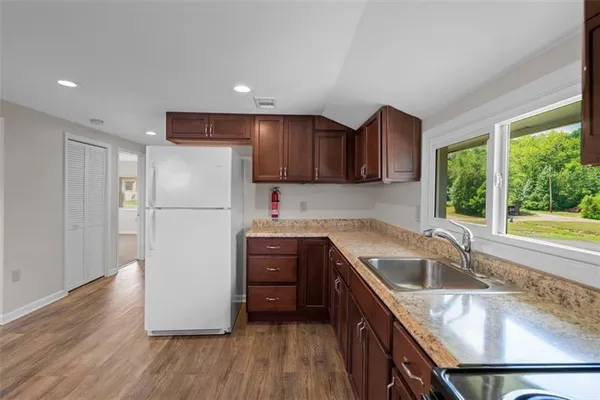 a kitchen with wooden cabinets and refrigerator