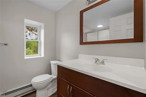 a bathroom with a sink mirror and toilet