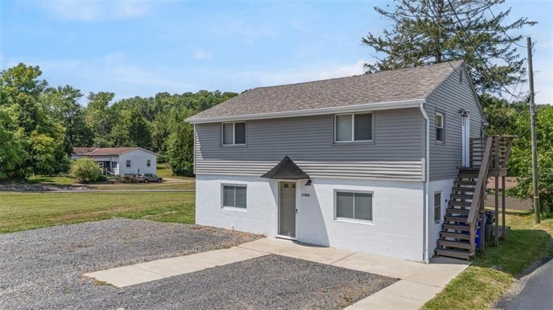 1122 Pittsburgh Road Valencia, PA 16059 - Photo 25 of 25 a front view of a house with a yard and garage