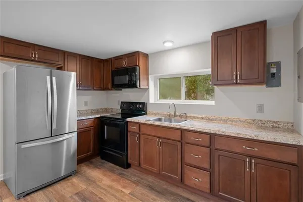 a kitchen with a refrigerator stove and sink