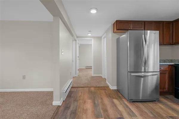 a view of a refrigerator in kitchen and wooden floor