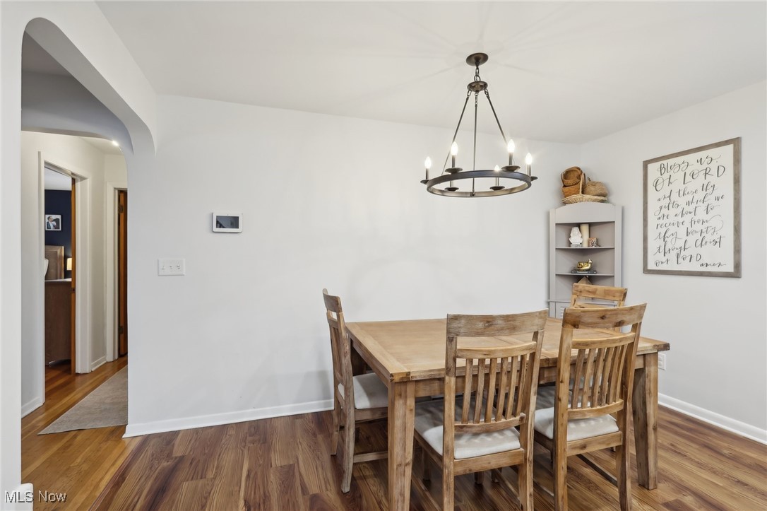 6086 Crossview Road Independence, OH 44131 - Photo 11 of 44 Dining area featuring dark hardwood / wood-style flooring and a notable chandelier