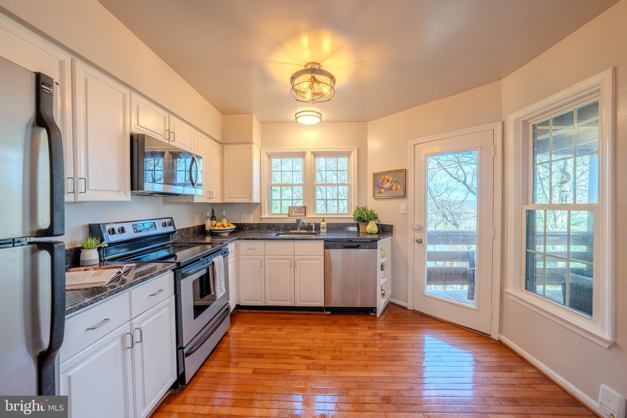 11168 Beaver Trail Court Reston, VA 20191 - Photo 17 of 42 a kitchen with stainless steel appliances granite countertop a stove a sink and a refrigerator