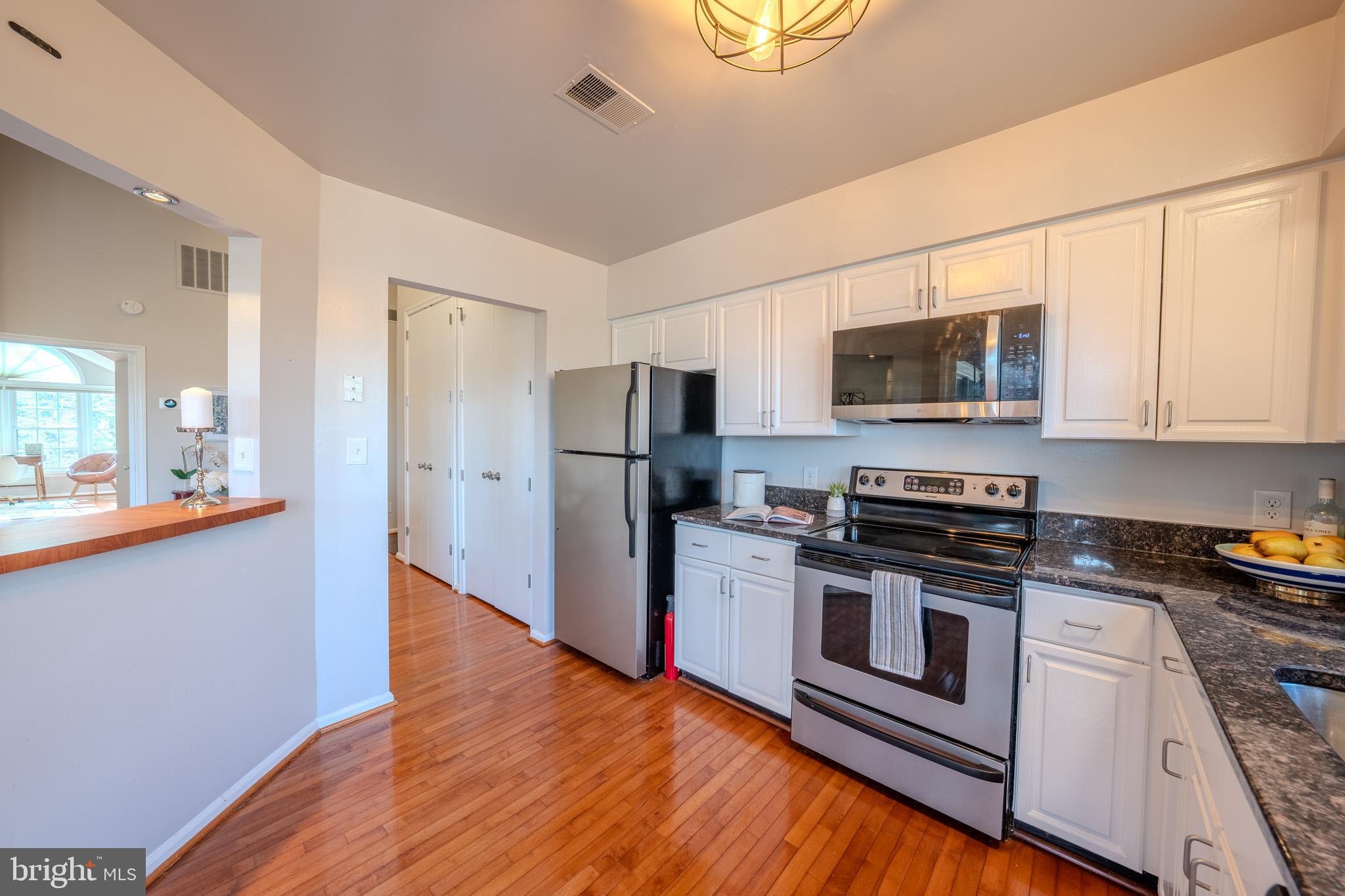11168 Beaver Trail Court Reston, VA 20191 - Photo 19 of 42 a kitchen with stainless steel appliances a stove microwave and refrigerator