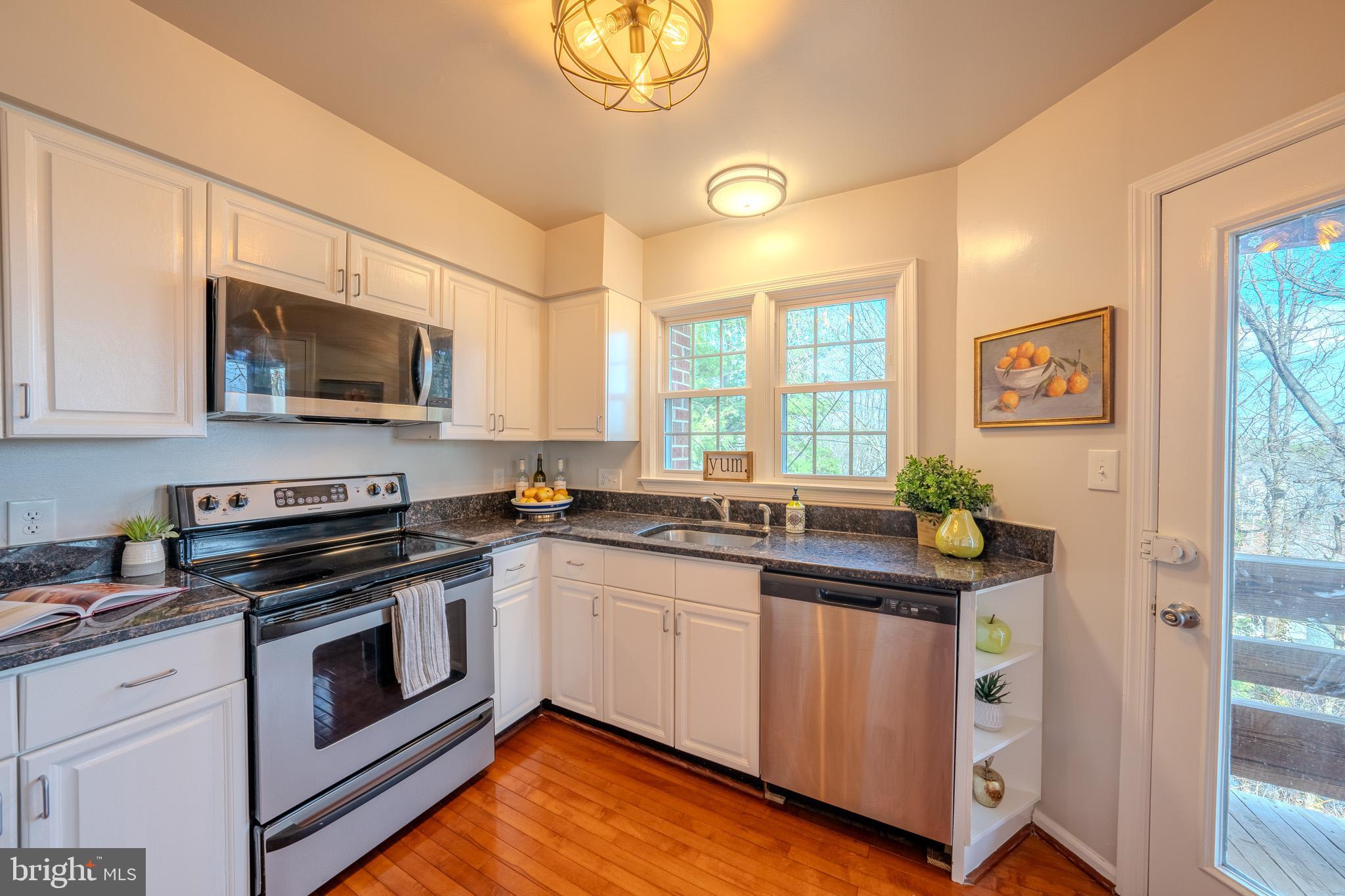 11168 Beaver Trail Court Reston, VA 20191 - Photo 20 of 42 a kitchen with stainless steel appliances granite countertop a stove and a sink