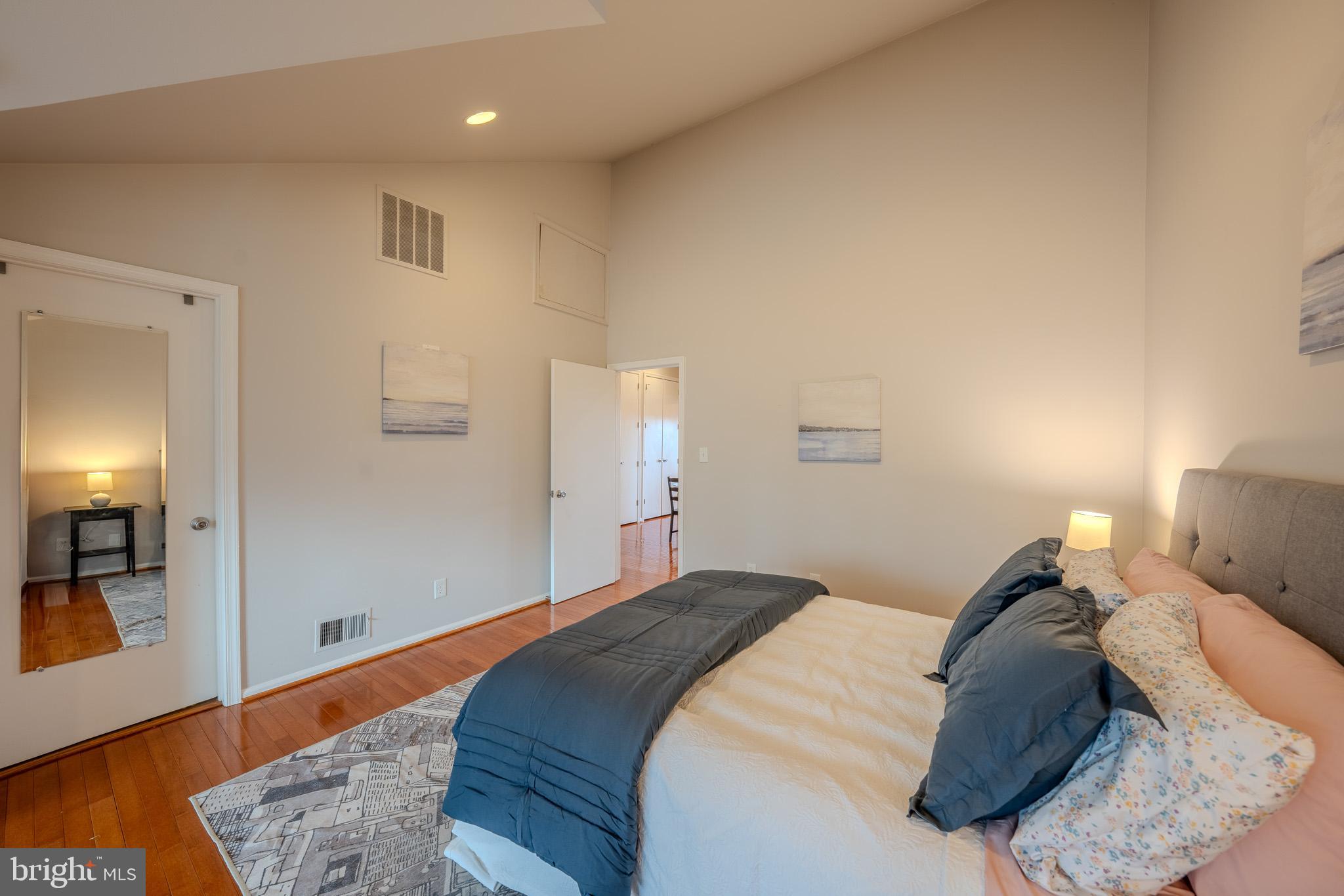 11168 Beaver Trail Court Reston, VA 20191 - Photo 27 of 42 a bedroom with a bed and mirror