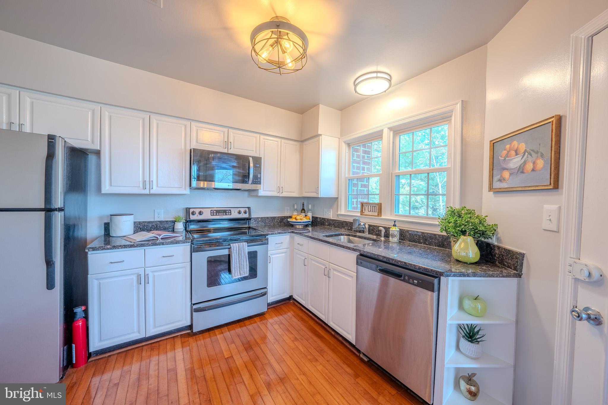 11168 Beaver Trail Court Reston, VA 20191 - Photo 5 of 42 a kitchen with stainless steel appliances granite countertop a stove and a sink