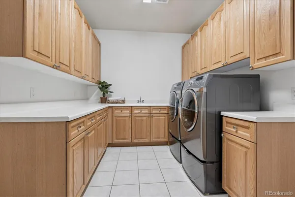 a utility room with sink dryer and washer