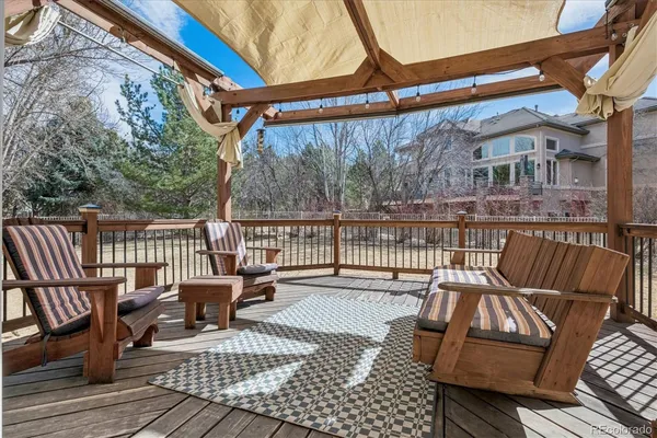 a view of balcony with wooden floor and outdoor seating