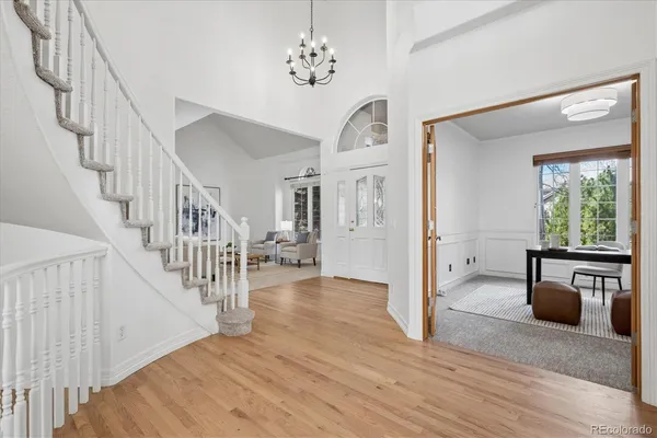 a view of entryway and hall with wooden floor