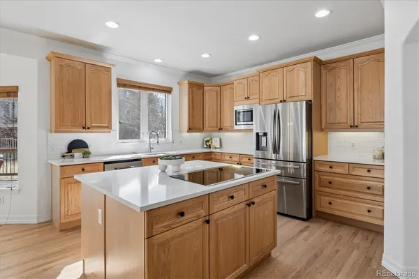 a kitchen with a refrigerator a sink and cabinets