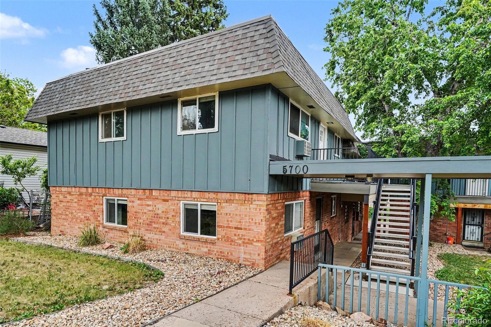 5700 West 28th Avenue, Unit 1 Wheat Ridge, CO 80214 - Photo 19 of 25 a front view of a house with garden