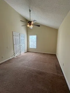 en empty room with windows and ceiling fan view