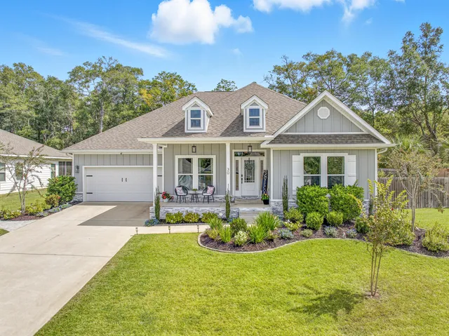 a front view of a house with a yard and porch